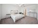 Bright bedroom with white walls, carpet floors, ceiling fan, and modern furniture at 71 Rose Bud Ln, Spring Hill, FL 34609