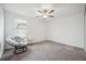 Well-lit bedroom with comfortable Papasan chair and carpet flooring at 71 Rose Bud Ln, Spring Hill, FL 34609