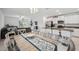 Stylish dining and living area showcasing modern decor, a large window, and an open layout to the kitchen at 71 Rose Bud Ln, Spring Hill, FL 34609