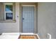 Charming front door entrance with a Welcome mat, secure lock and doorbell, framed by an inviting window at 71 Rose Bud Ln, Spring Hill, FL 34609
