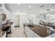 Modern kitchen with stainless steel appliances, a spacious island, and ample white cabinetry for storage at 71 Rose Bud Ln, Spring Hill, FL 34609