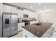Bright kitchen with stainless steel appliances, granite countertops, a breakfast bar, and ample cabinet space at 71 Rose Bud Ln, Spring Hill, FL 34609