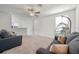 Bright, spacious living room with plush sofas and hanging chair at 71 Rose Bud Ln, Spring Hill, FL 34609
