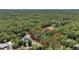 Aerial view of property with a red boundary line, featuring lush trees and a swimming pool at 7644 Conrad St, Wesley Chapel, FL 33544