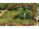 Beautiful aerial view of a wooded homesite lot surrounded by lush greenery and mature trees at 7644 Conrad St, Wesley Chapel, FL 33544