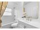 Bathroom showcasing a tub, toilet, vanity with modern gold-tone fixtures, and a framed mirror at 7644 Conrad St, Wesley Chapel, FL 33544