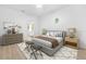 Cozy bedroom with a neutral color scheme, area rug, ceiling fan, and decorative accessories at 7644 Conrad St, Wesley Chapel, FL 33544