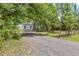 Charming home with a welcoming driveway, surrounded by mature trees at 7644 Conrad St, Wesley Chapel, FL 33544