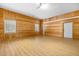 Spacious garage featuring wood paneling, windows for natural light, and a clean aesthetic at 7644 Conrad St, Wesley Chapel, FL 33544