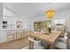 Modern kitchen and dining area with stainless steel appliances and a stylish chandelier at 7644 Conrad St, Wesley Chapel, FL 33544