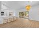 Open-concept kitchen with white cabinetry, marble countertops, and views of the screened in back patio at 7644 Conrad St, Wesley Chapel, FL 33544