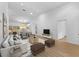 Bright open-concept living room with modern furniture and wood-look floors at 7644 Conrad St, Wesley Chapel, FL 33544