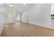 Open living area with vaulted ceilings and light wood-look floors at 7644 Conrad St, Wesley Chapel, FL 33544