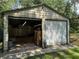 Large detached outbuilding with roll-up doors and durable metal construction at 7644 Conrad St, Wesley Chapel, FL 33544
