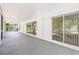Covered screened porch with view of trees and landscape; patio doors provide natural light at 7644 Conrad St, Wesley Chapel, FL 33544