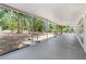 Covered screened porch featuring an expansive view of the surrounding trees and lush landscape at 7644 Conrad St, Wesley Chapel, FL 33544