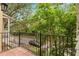 Balcony with tile flooring and black metal railing overlooking a street with lush trees at 918 Sombra Street, Tampa, FL 33619