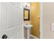 Stylish half-bathroom featuring a pedestal sink and attractive wallpaper at 918 Sombra Street, Tampa, FL 33619