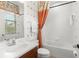 Bathroom with a single vanity, a shower with a curtain, and a window with blinds at 918 Sombra Street, Tampa, FL 33619