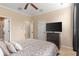 Cozy bedroom featuring a neutral decor, a ceiling fan, and ensuite bathroom access at 918 Sombra Street, Tampa, FL 33619
