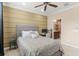 Comfortable bedroom featuring a ceiling fan, desk area, and ample natural light at 918 Sombra Street, Tampa, FL 33619