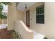 Inviting front entrance with a charming red door, concrete steps, and a convenient window at 918 Sombra Street, Tampa, FL 33619