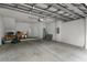 Spacious garage interior with concrete floor, storage items, and a white door at 918 Sombra Street, Tampa, FL 33619