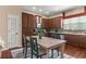 Stylish kitchen featuring dark wood cabinets, stainless steel appliances, and a dining area at 918 Sombra Street, Tampa, FL 33619