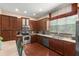 Well-lit kitchen with dark cabinets, stainless steel appliances, and a view of the window at 918 Sombra Street, Tampa, FL 33619