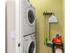 Functional laundry area with stacked washer and dryer and convenient storage options at 918 Sombra Street, Tampa, FL 33619