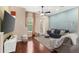 Comfortable living room with hardwood floors, blue accent wall, and plenty of natural light at 918 Sombra Street, Tampa, FL 33619