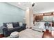 Open-concept living room with hardwood floors, blue accent wall, and a kitchen view at 918 Sombra Street, Tampa, FL 33619