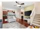 Bright living area showcasing hardwood floors, an open staircase, and a spacious layout at 918 Sombra Street, Tampa, FL 33619