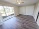 Bedroom with ceiling fan, sliding glass doors to a screened in porch, and two closets at 9217 Tudor Dr # A106, Tampa, FL 33615