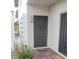 Close up of a unit entrance with security screen door and welcome mats at 9217 Tudor Dr # A106, Tampa, FL 33615