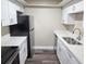 Bright kitchen with white cabinets, quartz countertops, and stainless steel appliances at 9217 Tudor Dr # A106, Tampa, FL 33615