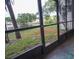 View from screened lanai overlooking water and lush green landscape at 9217 Tudor Dr # A106, Tampa, FL 33615