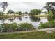 Beautiful waterfront view of the calm water reflecting the surrounding homes and lush trees at 9217 Tudor Dr # A106, Tampa, FL 33615