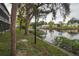 Scenic waterfront view with lush greenery, trees, and community docks along the tranquil canal at 9217 Tudor Dr # A106, Tampa, FL 33615
