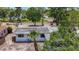 Aerial view of a single-story home with mature trees and tropical landscaping at 922 Alcazar S Way, St Petersburg, FL 33705