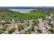 An aerial view of a neighborhood featuring mature trees and a glimpse of a lake nearby at 922 Alcazar S Way, St Petersburg, FL 33705