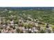 Aerial view showing surrounding neighborhood, mature trees and tropical landscaping at 922 Alcazar S Way, St Petersburg, FL 33705