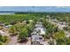 Aerial view showing surrounding neighborhood, lake and mature tropical landscaping at 922 Alcazar S Way, St Petersburg, FL 33705