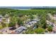 Aerial view showing surrounding neighborhood, lake and mature tropical landscaping at 922 Alcazar S Way, St Petersburg, FL 33705