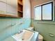 Bathroom with turquoise tile, sink, and window at 922 Alcazar S Way, St Petersburg, FL 33705