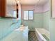Bathroom with turquoise tile, sink, and bathtub at 922 Alcazar S Way, St Petersburg, FL 33705