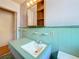 Bathroom with turquoise tile, vanity, and mirror at 922 Alcazar S Way, St Petersburg, FL 33705