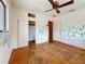 Bedroom with hardwood floors, ceiling fan, closet and a view from the window at 922 Alcazar S Way, St Petersburg, FL 33705