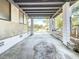 Attached carport with concrete floor, stone accent wall, and view to neighborhood street at 922 Alcazar S Way, St Petersburg, FL 33705