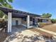 Attractive single-story home with covered carport, featuring stone accents, mature plantings, and a well-maintained front yard at 922 Alcazar S Way, St Petersburg, FL 33705